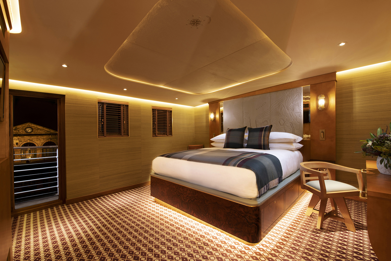 Bedroom picture on board Fingal Hotel. Lights are glowing warm yellow and it's a relaxing atmosphere.