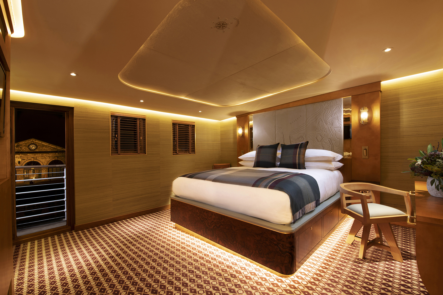 Bedroom picture on board Fingal Hotel. Lights are glowing warm yellow and it's a relaxing atmosphere.