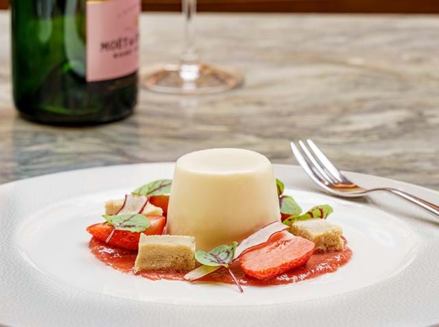 Panacotta pudding served with pieces of strawberries and shortbread