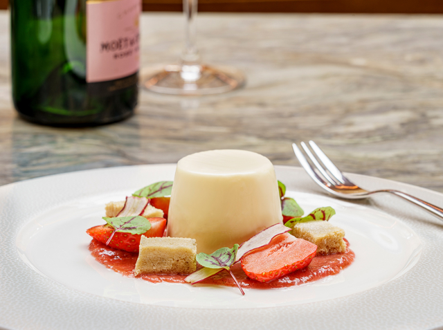 Panacotta pudding served with pieces of strawberries and shortbread
