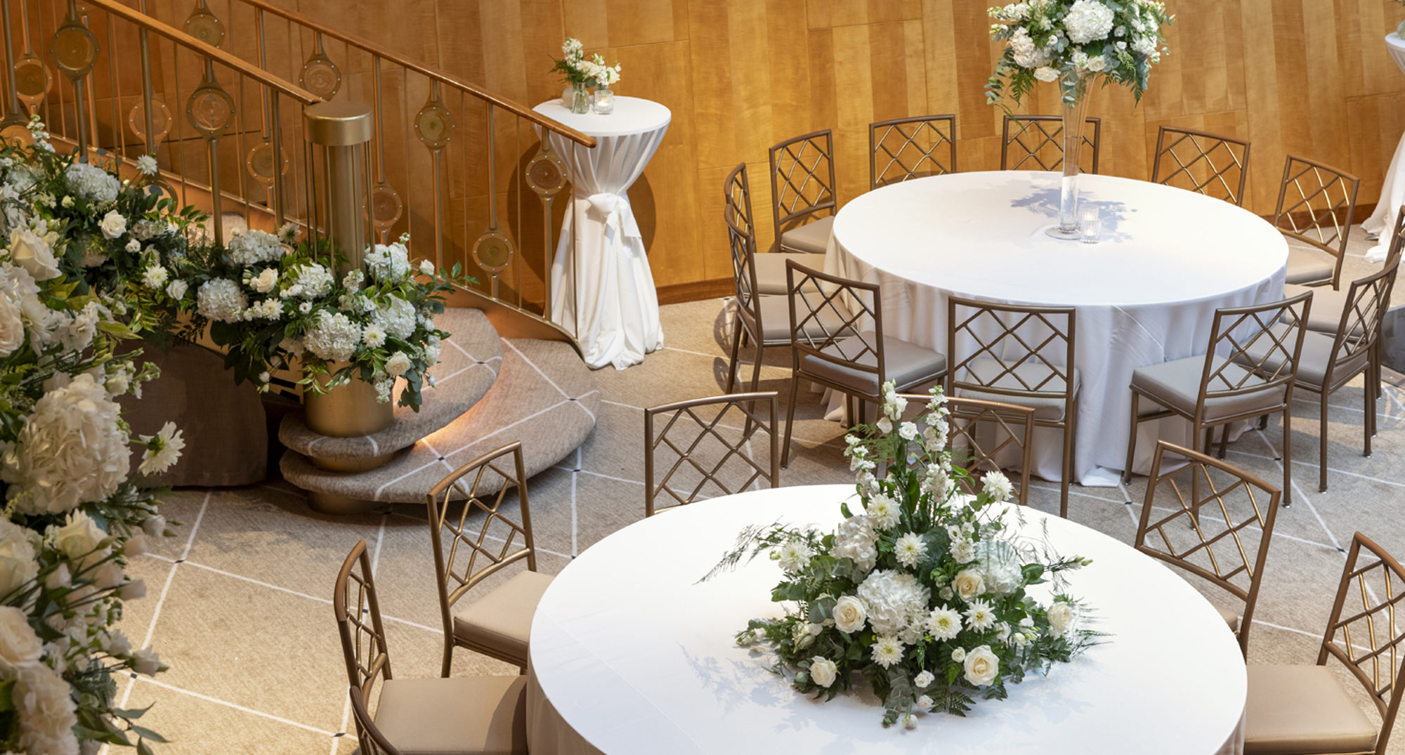 Ballroom with white tablecloths and stunning white flowers - Alix McIntosh