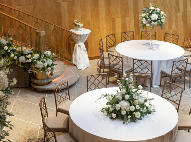 Ballroom with white tablecloths and stunning white flowers - Alix McIntosh