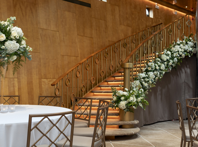 Beautiful flowers adorn the staircase in the Ballroom