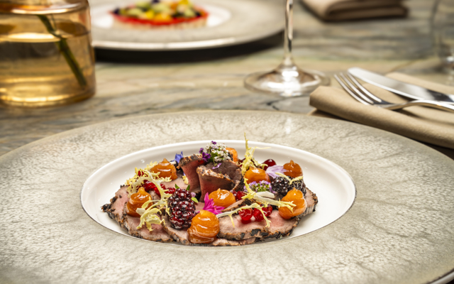 A starter dish of smoked Strathdon red deer salad, lingonberries, sherry blackberries, quince jelly