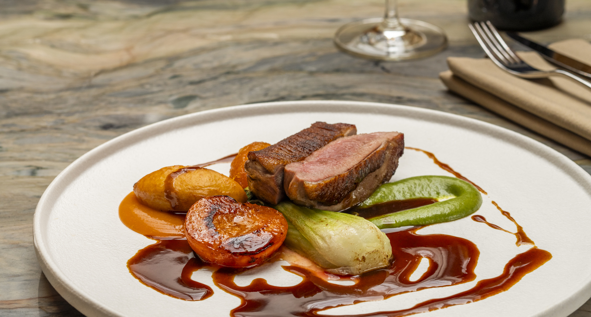 A main dish of Borders grass-fed lamb rump, goats’ cheese gnocchi, aubergine galette, minted port sauce. 