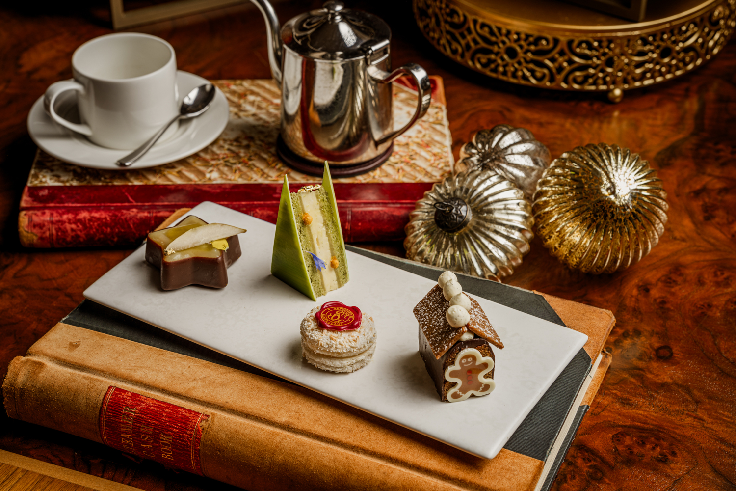 Festive afternoon tea selection aboard Fingal in Edinburgh at Christmas, featuring seasonal pastries and elegant miniature desserts