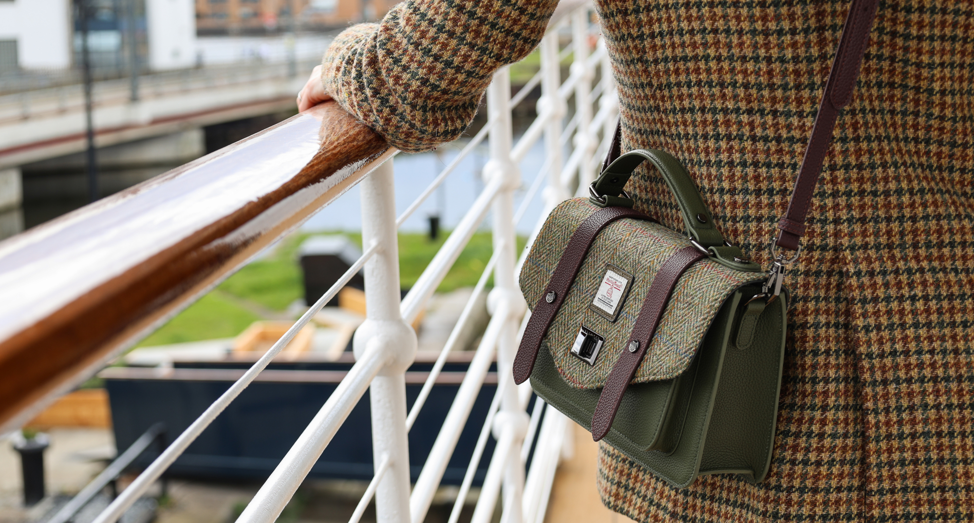 Out on deck, model wears the handbag