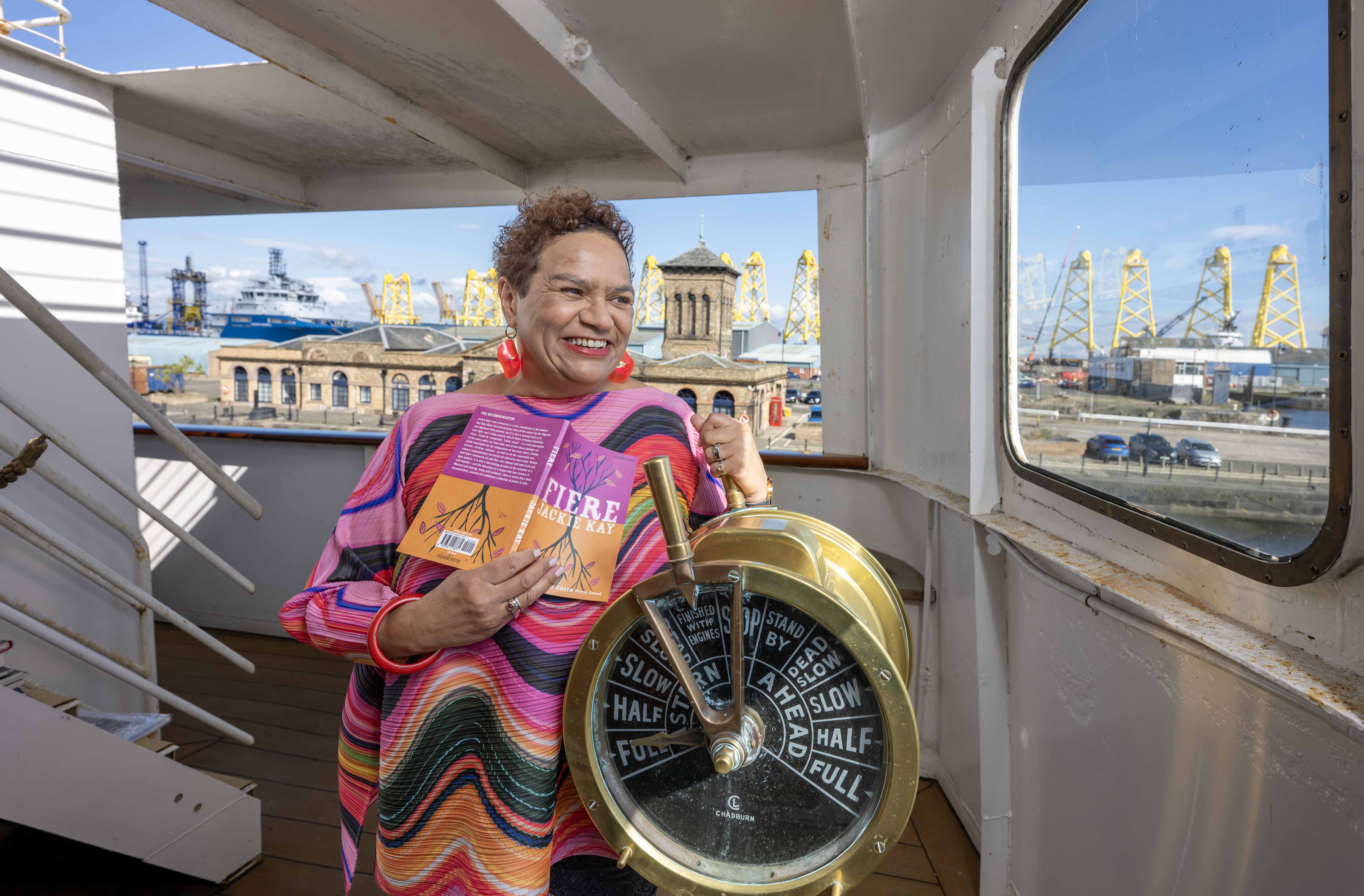 A woman on the deck of a ship with a telegraph,