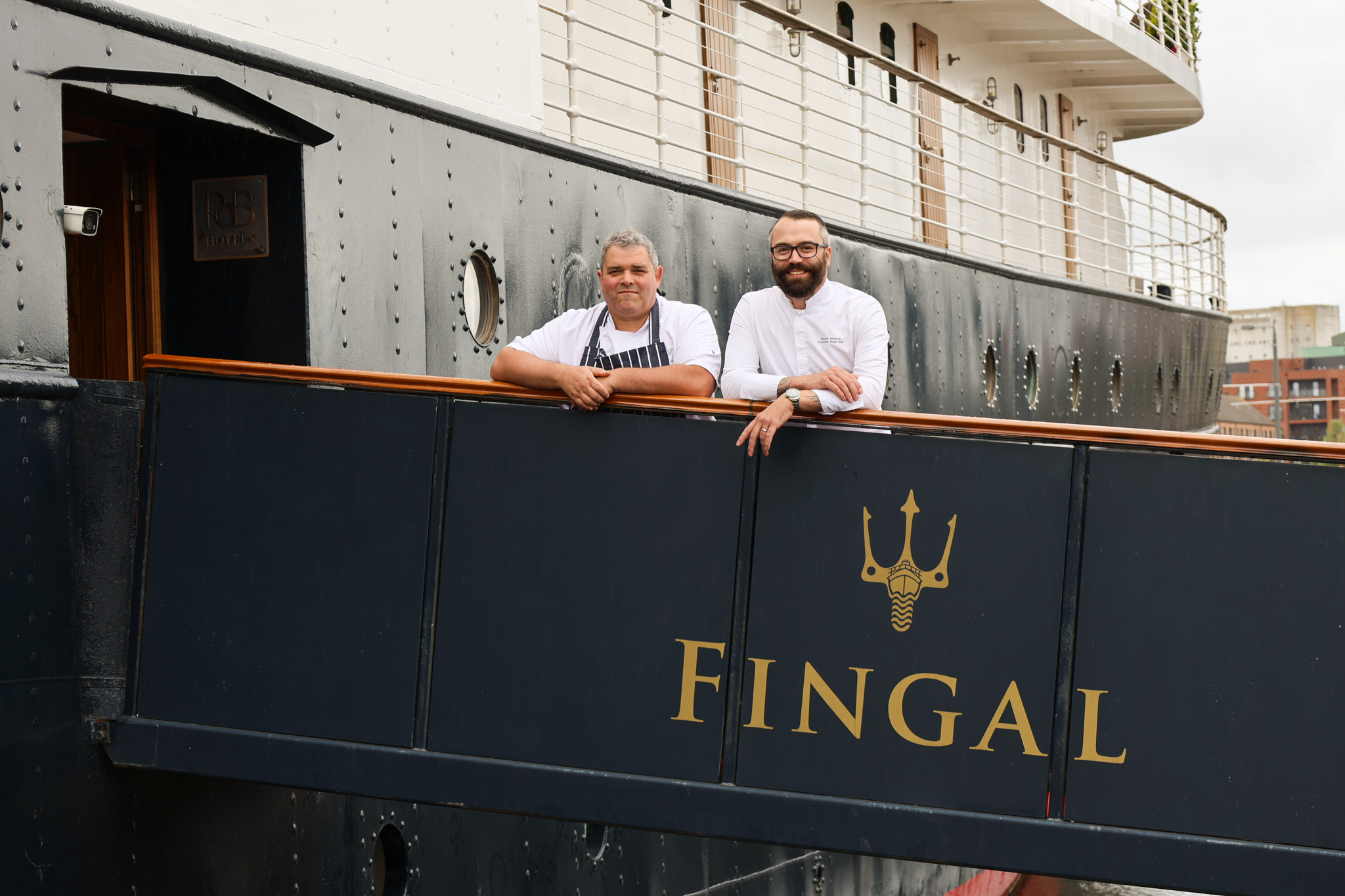 Two chefs on a gangway onto a ship