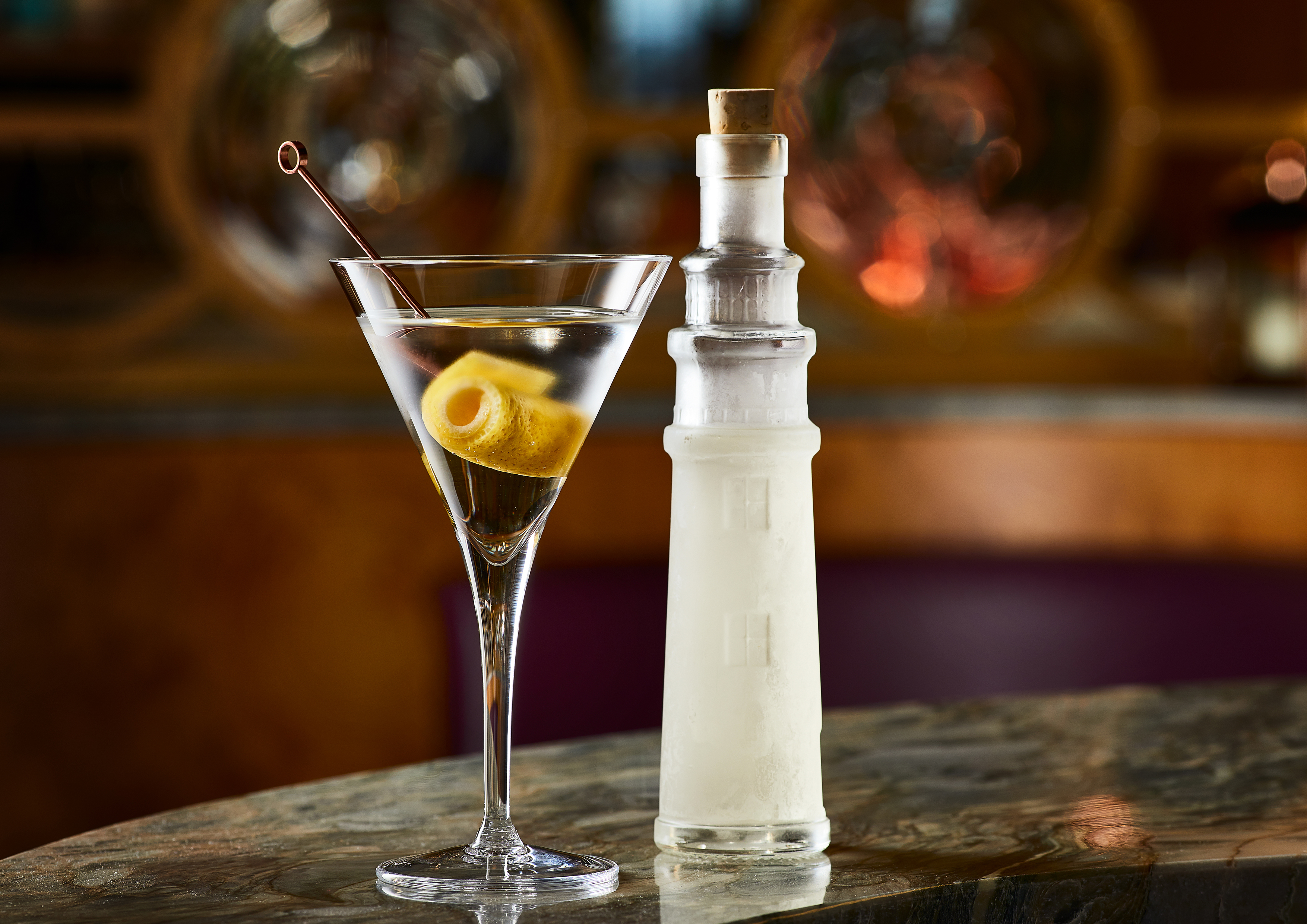 Cocktail and a glass shaped like a lighthouse.