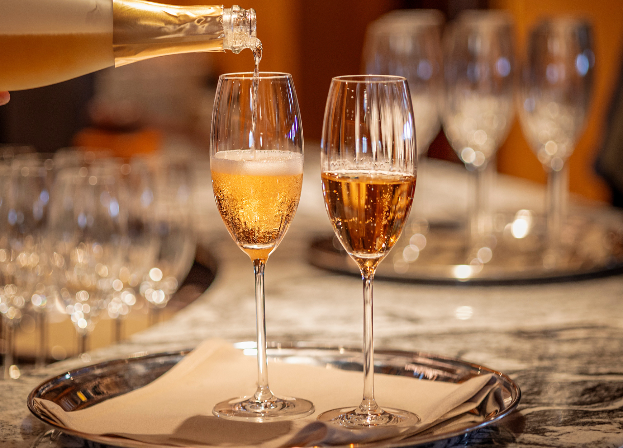 Glasses of fizz are poured. 