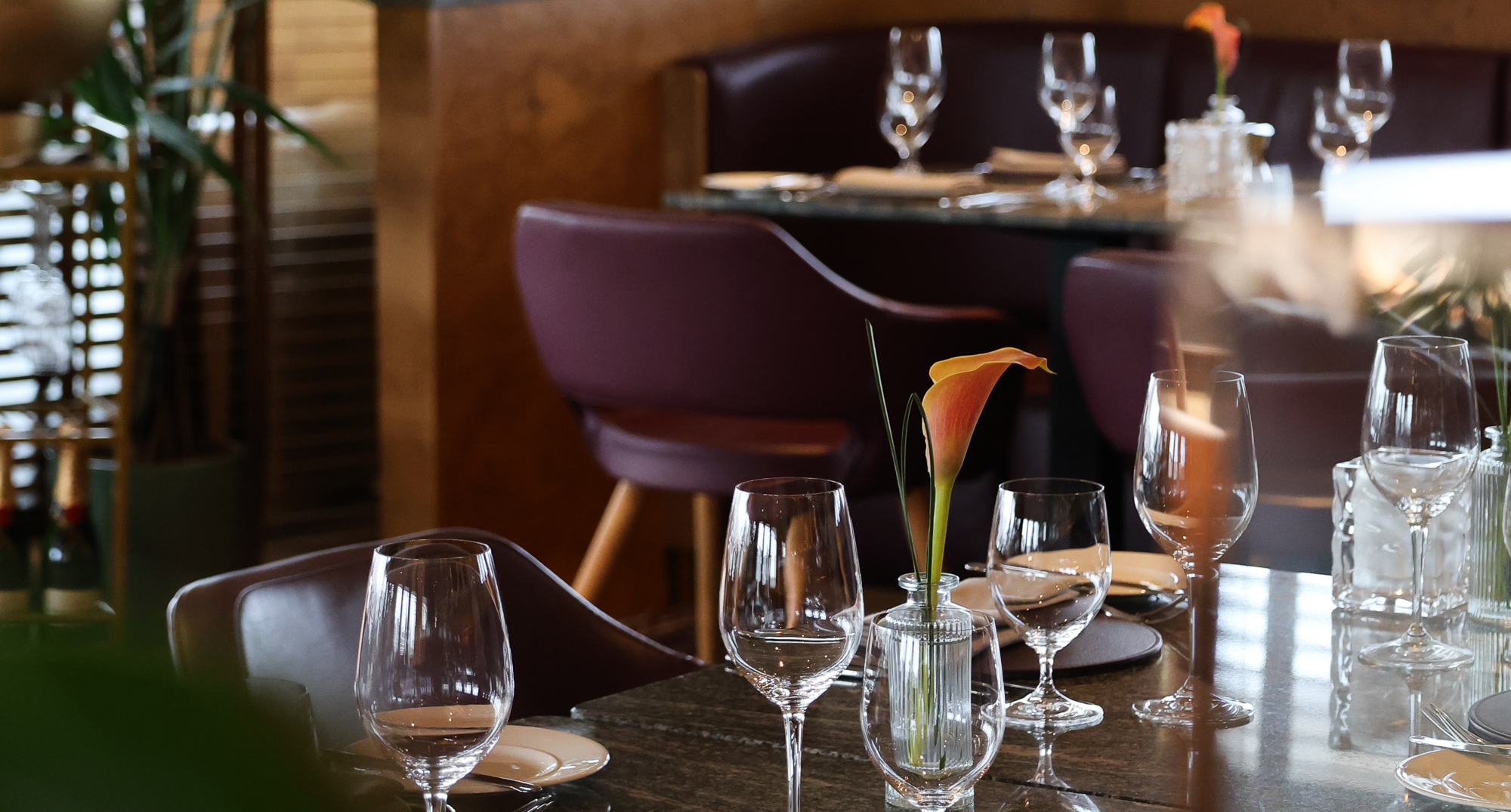 Table is set for dinner in a low light setting.