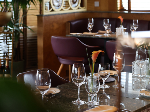 Table is set for dinner in a low light setting.