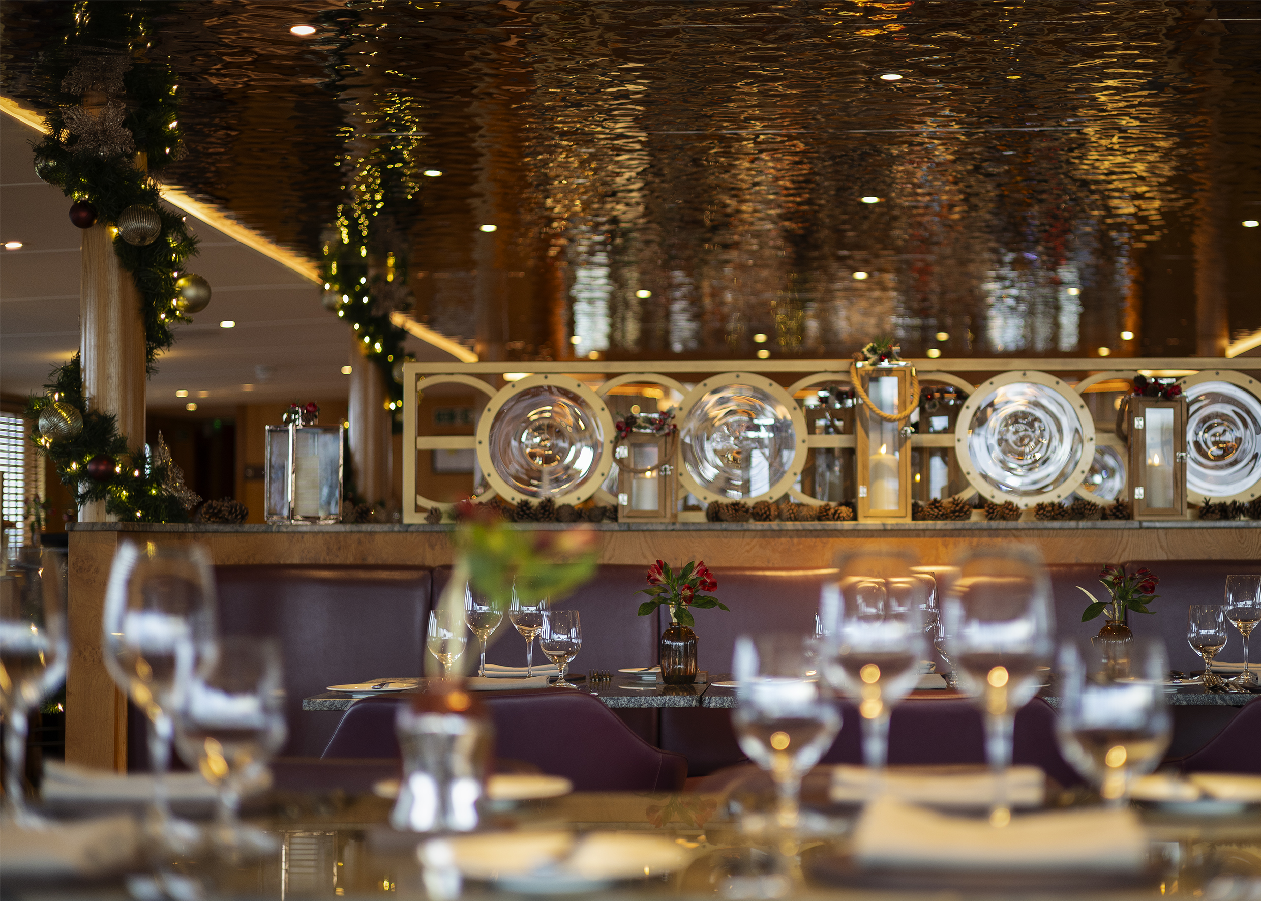 The Lighthouse Restaurant Aboard Fingal Decorated For Christmas. the tables are set and there are decorations and lights around the restaurant