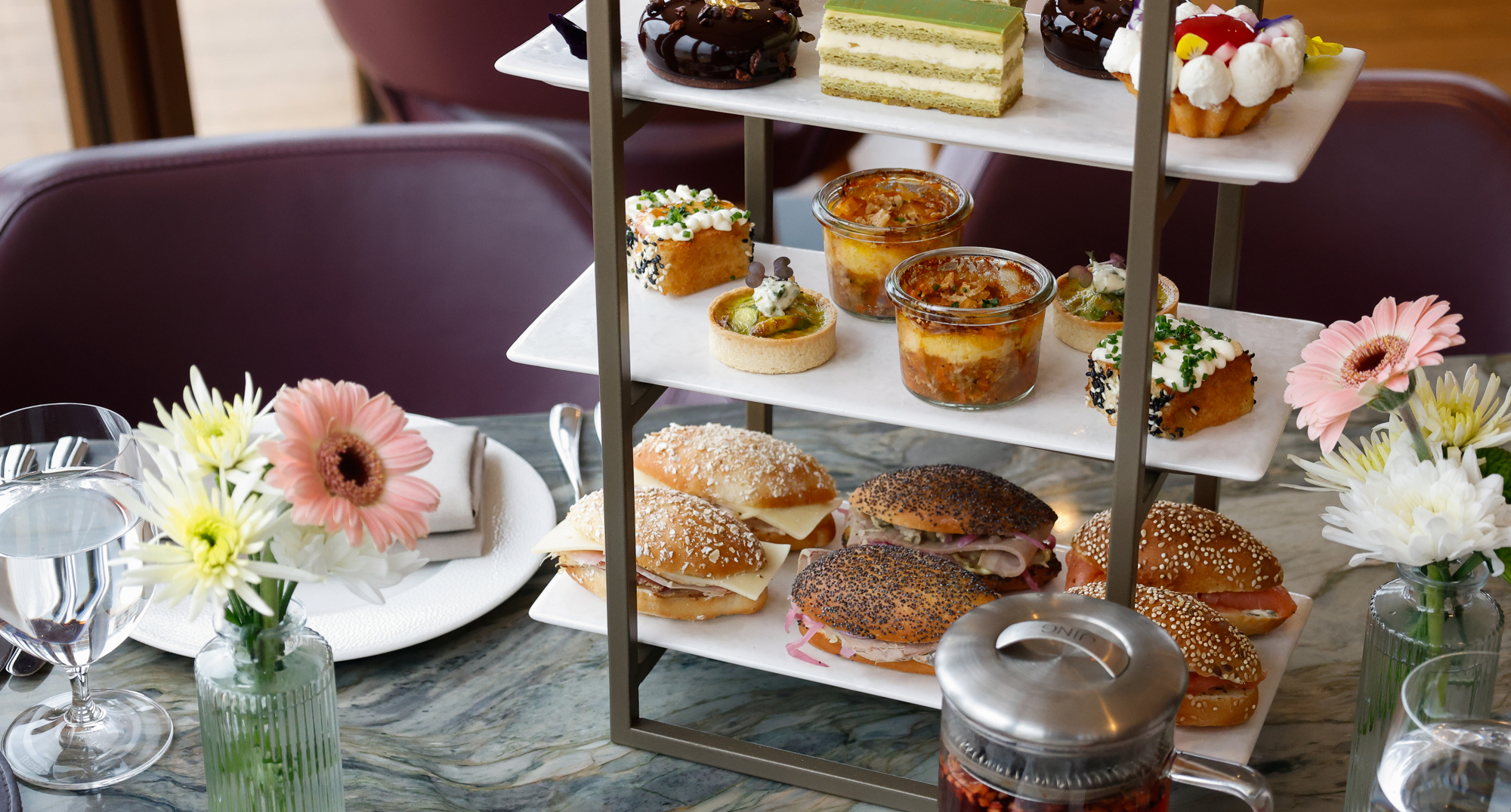 A tiered cake stand containing sweet and savoury treats. 