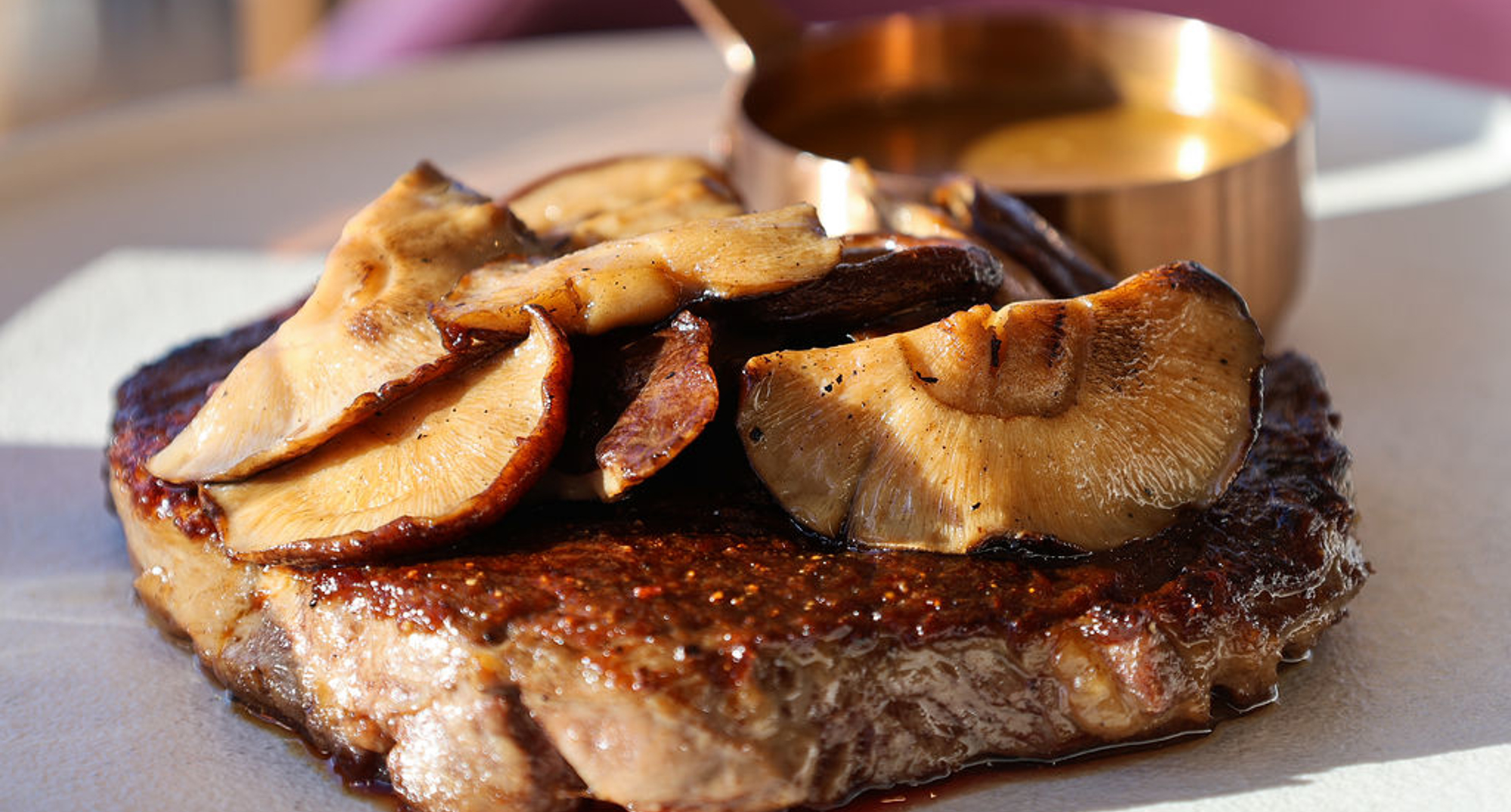 Miso-glazed Scottish 10oz ribeye steak, shiitake mushrooms, Fingal fries, peppercorn sauce in the sunshine 