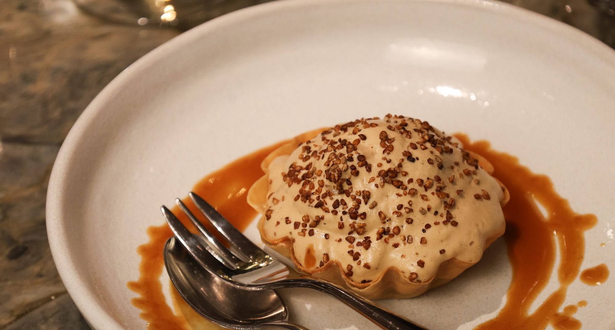 Dessert on a plate with syrup nicely poured around it. 