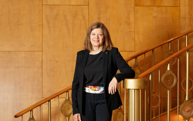 Woman standing on staircase posing for a photo