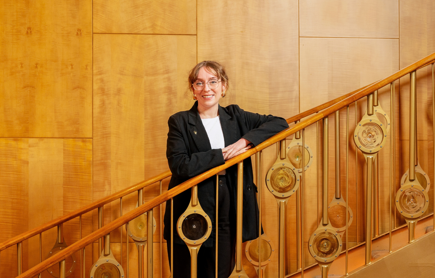 Woman standing on staircase posing for a photo