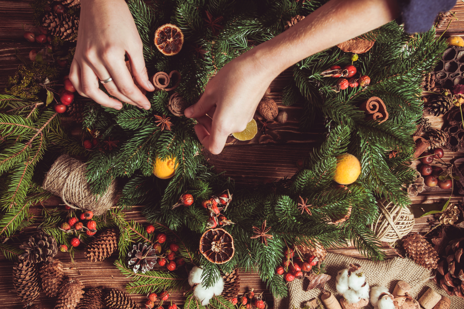 Hands craft a Christmas wreath during a festive wreath-making workshop event in an Edinburgh hotel 