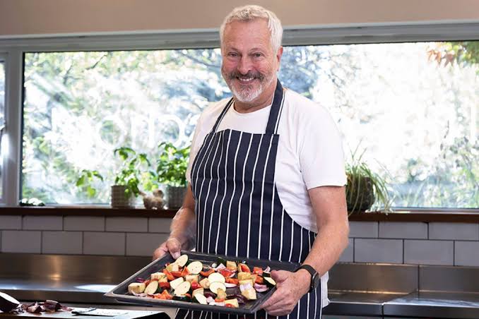 A Chef at a kitchen cooking.