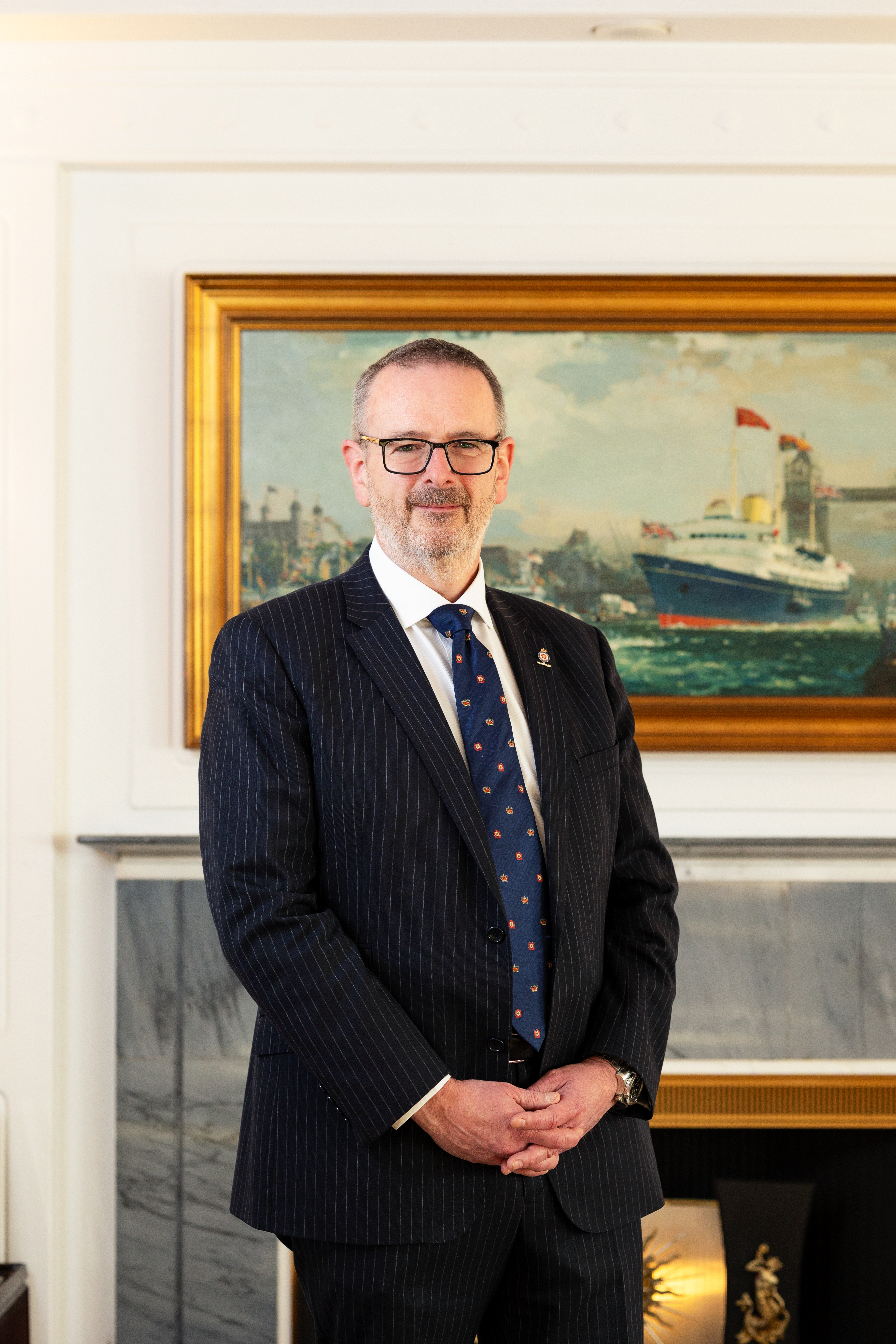 Man standing in front of painting for portrait.