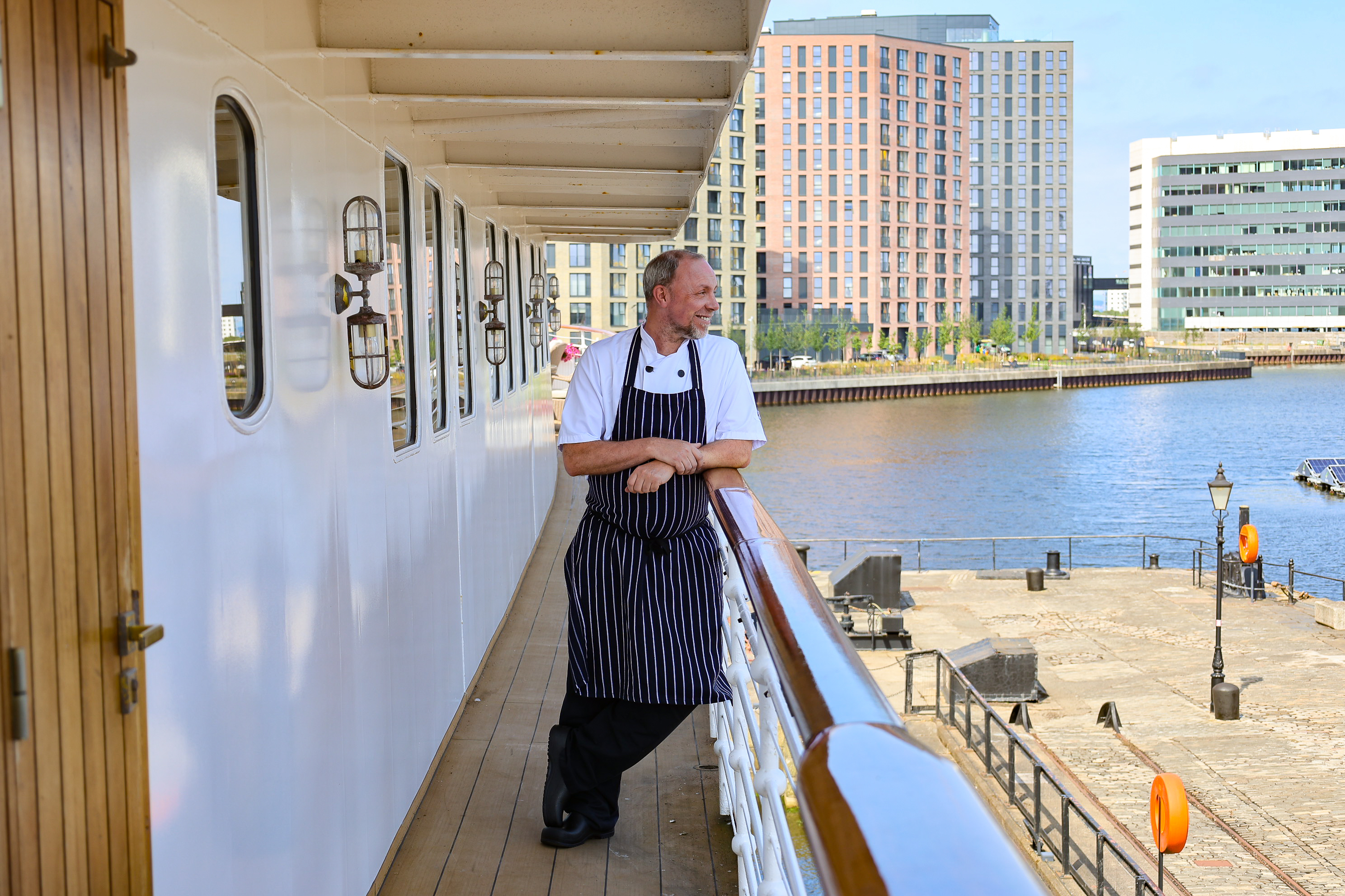 Chef on the deck of a ship.